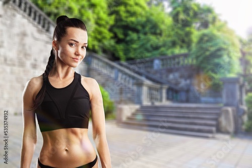 Young woman in sports outfit doing exercises outdoors in the morning. Sport woman, Active life, sports training, healthy lifestyle.