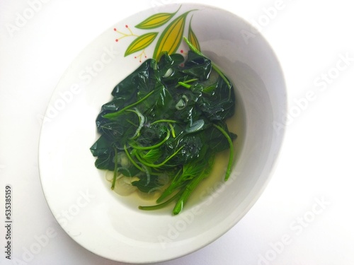 Sayur bayam or sayur bening is an Indonesian vegetable soup prepared from vegetables,primarily amaranth, in clear soup flavoured with temu kunci.It is commonly prepared as main course during breakfast photo