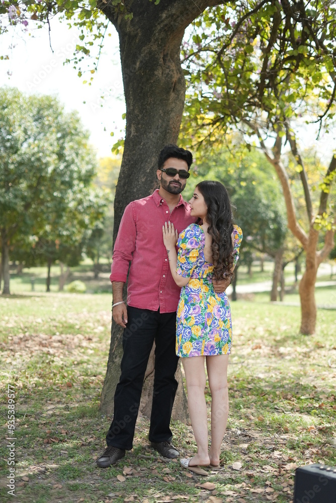 Fototapeta premium a couple wearing clothes doing fun a park