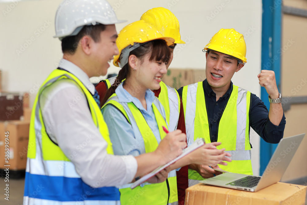 Group of technician engineer and businessman in protective uniform standing and discussing, researching, brainstorming and planning work with computer together at industry manufacturing factory Group of technician engineer and businessman in protective uniform standing and discussing, researching, brainstorming and planning work with computer together at industry manufacturing factory