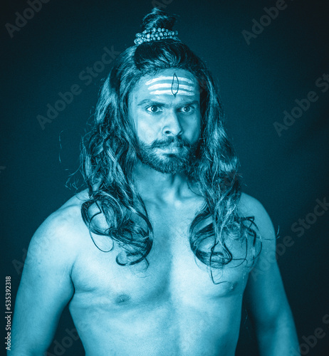 Blue tinged picture of a topless man