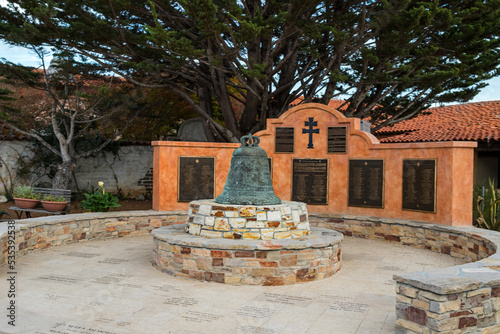 Mission bell in the courtyard, The Carmel Mission Basilica, the mission of San Carlos Borromeo, founded in 1770 by Junipero Serra, Carmel-by-the-Sea, California USA photo