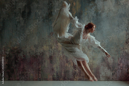 Woman in white dress painting