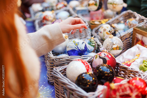 Woman picking Russian nesting dolls from basket photo