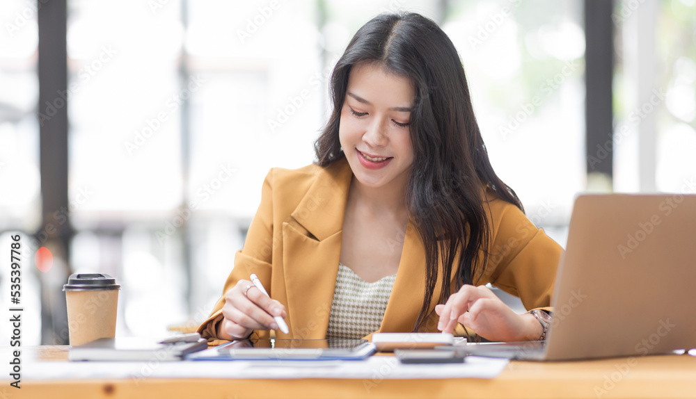 Business Asian woman using calculator for do math finance on Laptop, in workplace Office, business Working Financial, Business and Marketing Projects tax, accounting, statistics and analytic research Business Asian woman using calculator for do math finance on Laptop, in workplace Office, business Working Financial, Business and Marketing Projects tax, accounting, statistics and analytic research