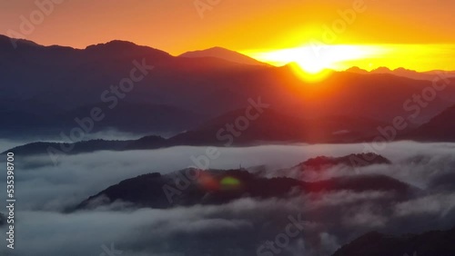 BREAUTIFUL SUNRISE above the flowing fog photo