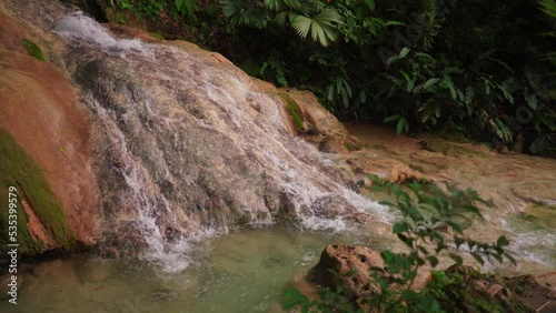 Waterfall in the forest name is Sungai Mudal Waterfall in Yogyakarta Indonesia, crystal clear waterfall, Waterfall with many beautiful plants and mosses. Very Fresh dan relaxing place. photo