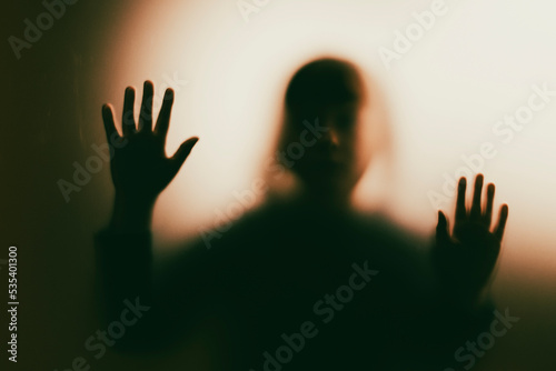 Obraz na plátne Shadowy figure, child behind glass - horror background
