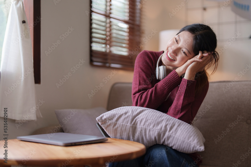 Young asian woman happy life sitting on couch cozy living room at home. The house was homely concept