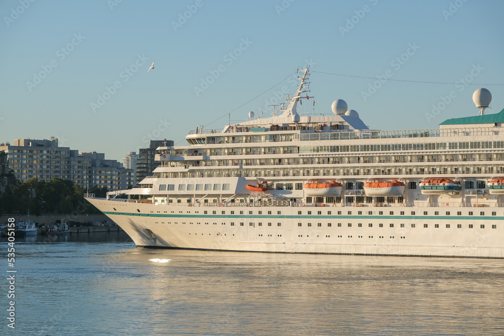 Phoenix cruiseship or cruise ship liner Amera in port of Montreal, Canada on sunny day on St. Lawrence River for Indian summer East Coast cruising with downtown skyline and terminal Phoenix cruiseship or cruise ship liner Amera in port of Montreal, Canada on sunny day on St. Lawrence River for Indian summer East Coast cruising with downtown skyline and terminal