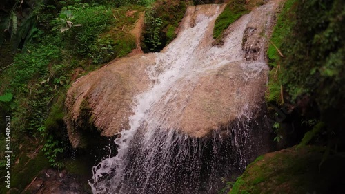 Waterfall in the forest name is Sungai Mudal Waterfall in Yogyakarta Indonesia, crystal clear waterfall, Waterfall with many beautiful plants and mosses. Very Fresh dan relaxing place. photo