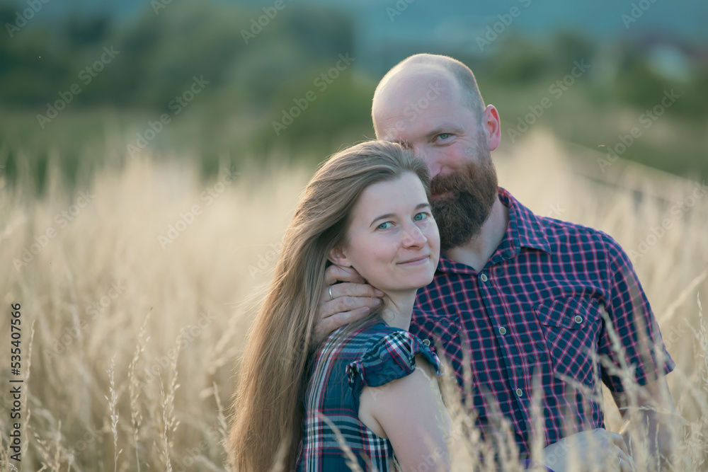 Young couple in love in the summer field Young couple in love in the summer field