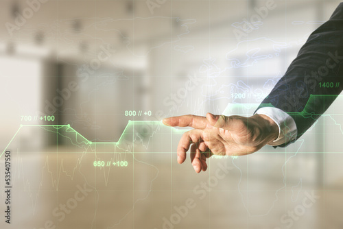 Man hand working with abstract virtual stats data hologram on blurred office background. Multiexposure