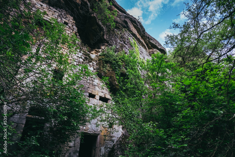 view on the facade of an abandoned troglodyte house in La Jaubernie, near Coux, Ardeche (south of France)