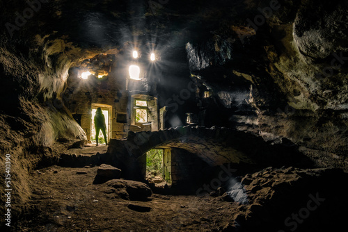Fotografie Silhouette of a woman standing in the entrance of an abandoned troglodyte house