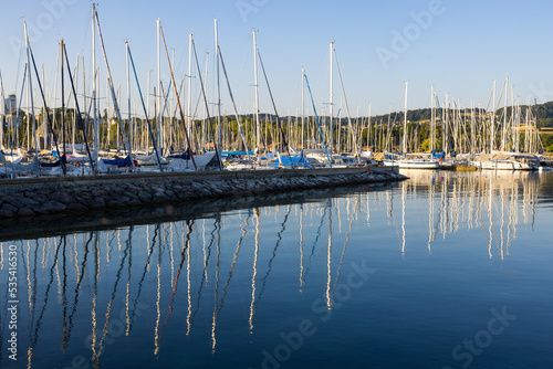 Sail boats and reflections in the harbour of Estavayer le Lac, Switzerland photo