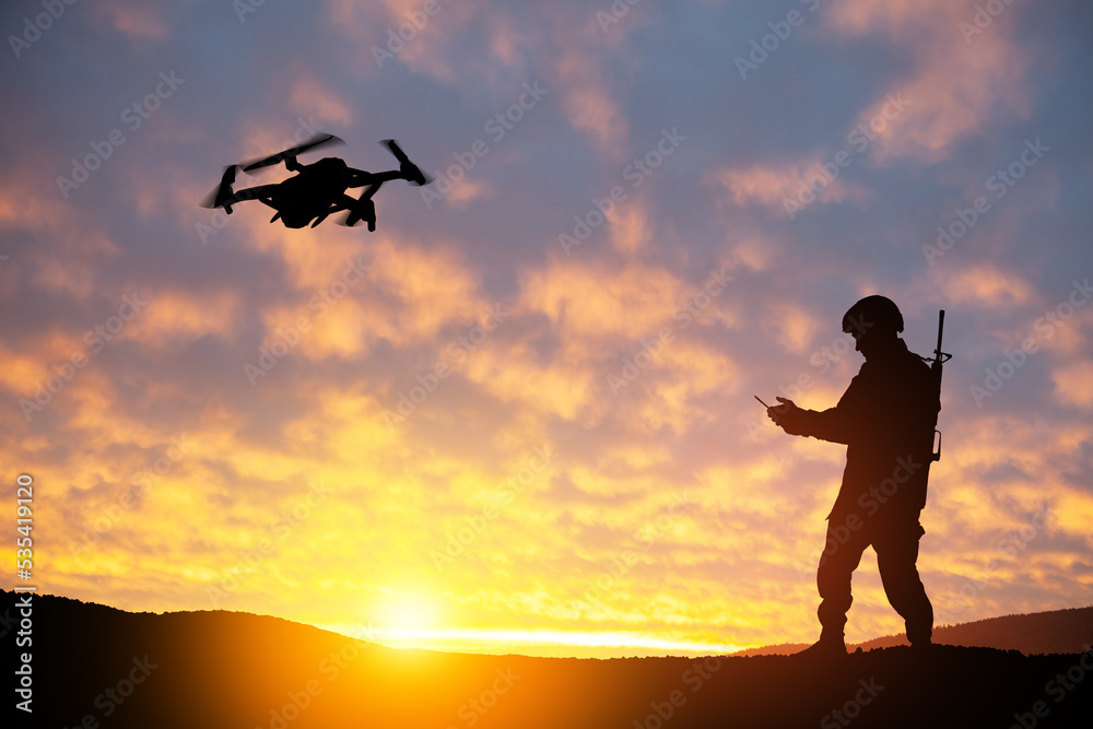 Silhouettes of soldiers are using drone and laptop computer for scouting during military operation against the backdrop of a sunset. Greeting card for Veterans Day, Memorial Day, Independence Day. Silhouettes of soldiers are using drone and laptop computer for scouting during military operation against the backdrop of a sunset. Greeting card for Veterans Day, Memorial Day, Independence Day.