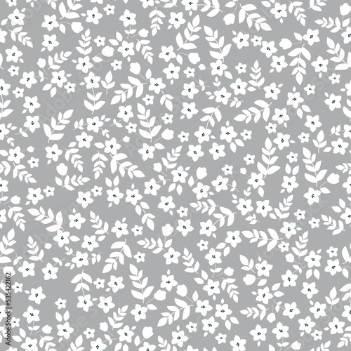 Simple vintage pattern. small white flowers and leaves. grey background. Fashionable print for textiles and wallpaper.