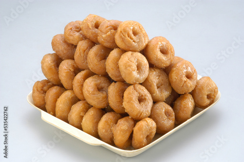 Badusha or Balushahi is a traditional indian sweet served duing festivals and clebrations stacked in white bowl