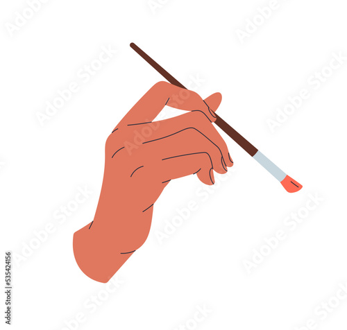 Brush in hand. Painters arm holding paintbrush, drawing, applying paint. Arti...