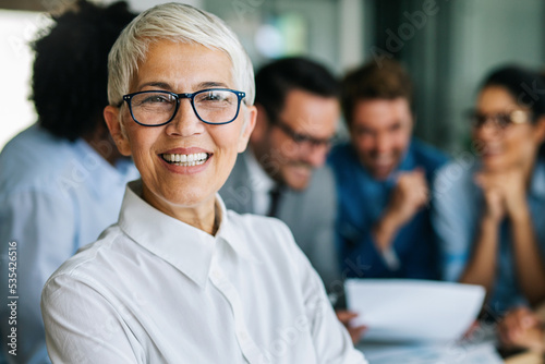 Group of multiethnic successful business people working and communicating at the office