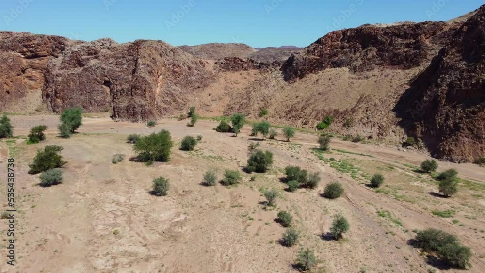 Scenic aerial landscape of a dry riverbed and mountain wilderness of northern Namibia Scenic aerial landscape of a dry riverbed and mountain wilderness of northern Namibia