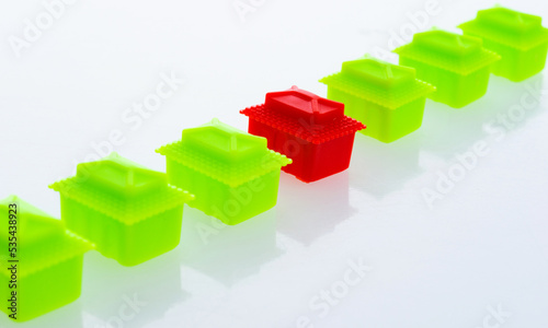 Many plastic toy houses on white background