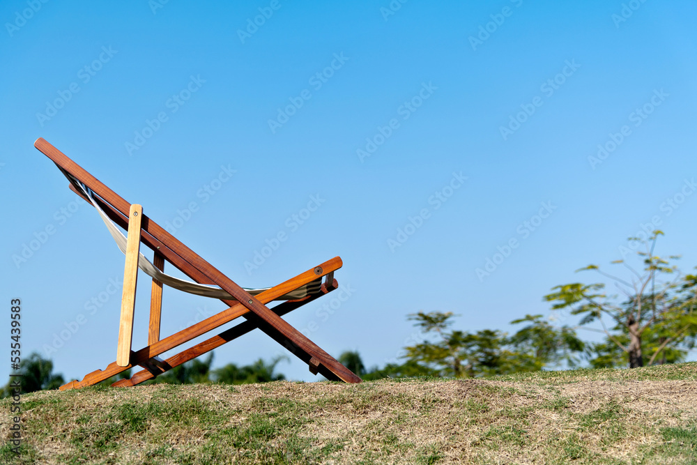 Deck chair on the meadow in the garden Deck chair on the meadow in the garden