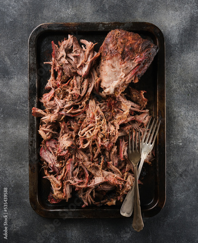 Traditional barbecue pulled pork. Slow cooked pulled pork shoulder. Juicy pork meat cooked in a smoker by low and slow