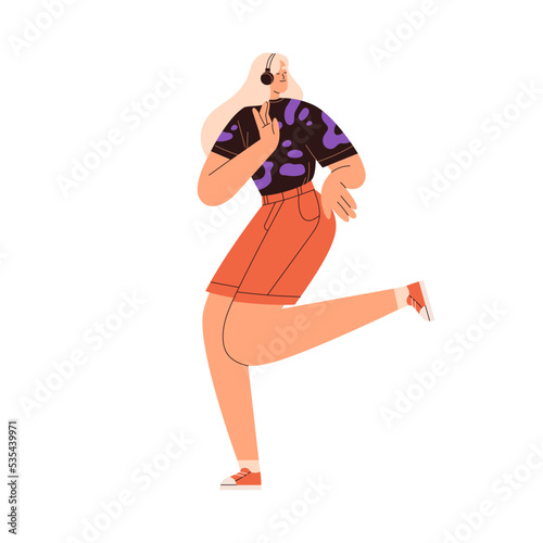 Happy girl in headphones. Young woman dancing with energy, listening to music...