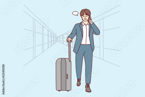 Young businessman with suitcase walking in airport talking on cellphone. Confident male boss in suit have smartphone call ready for business trip. Vector illustration. 
