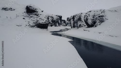 Obraz na płótnie Lost snowy river in iceland, a frozen stone canyon. w salonie