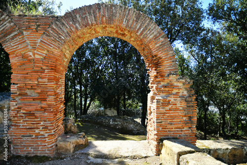 An arch among the ruins of Cuma, an ancient city near Naples, Italy. photo