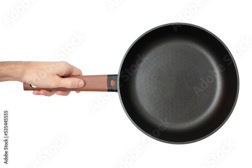 Fotótapéta Man is holding an empty black frying pan with a wooden handle