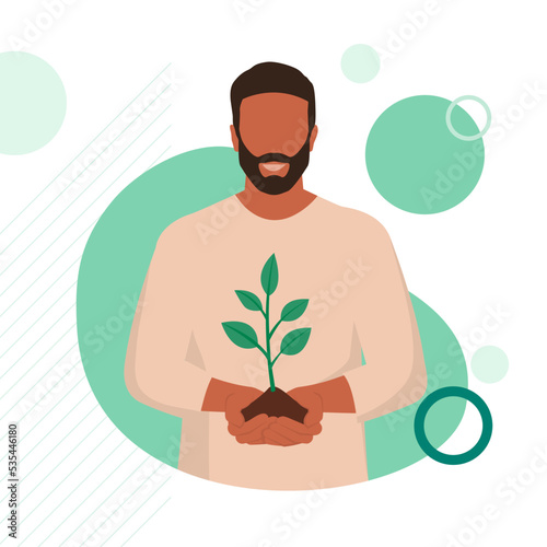 Smiling farmer holding soil and a sprouting plant