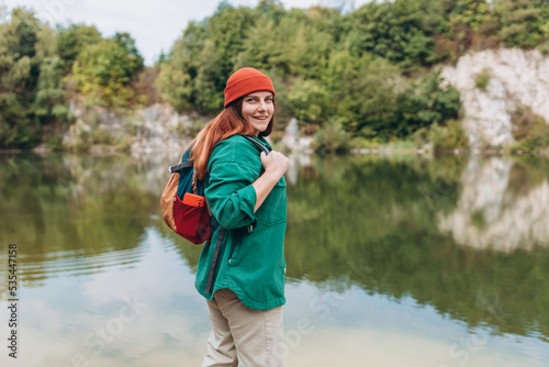 Woman hiking in woods. Adventure women enjoying view of majestic mountain lake explore travel. Freedom and active lifestyle concept. Amazing chill moment