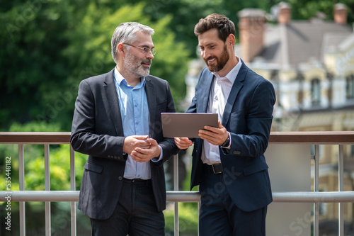 Two businessmen discussing the project details and looking involved