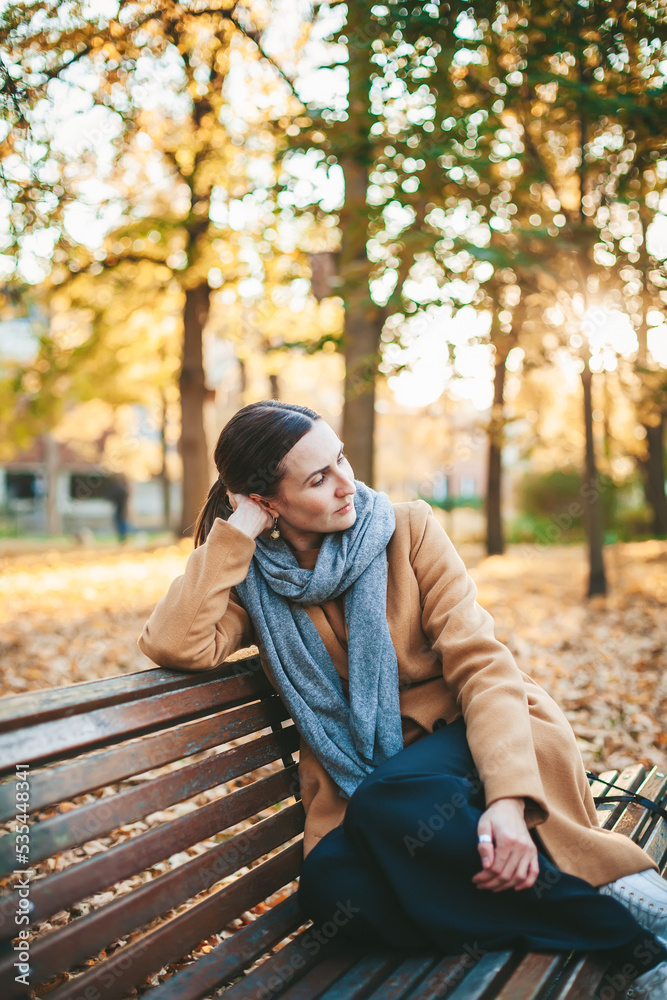 Pensive woman in the autumn park Pensive woman in the autumn park