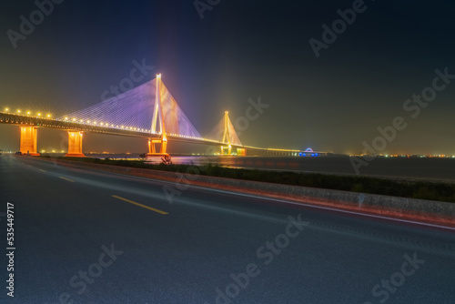 Suzhou Yangtze River Bridge, asphalt road and night view of the Yangtze River in China