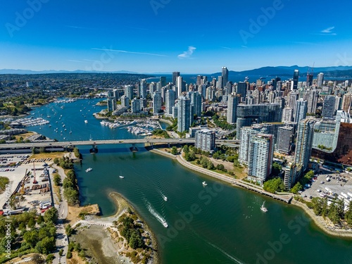 Aerial drone view of the downtown of Vancouver with modern buildings and a port with moored boats