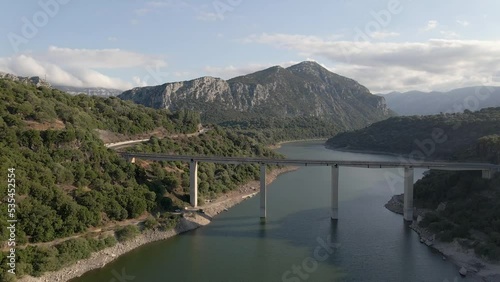 Drone footage over Lago del Cedrino lake on a sunny day photo