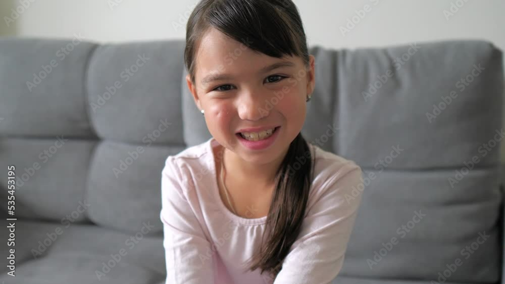 Close up portrait of caucasian little brunette girl in pink shirt smiling look at camera. Adorable kid smile. Happy childhood concept Close up portrait of caucasian little brunette girl in pink shirt smiling look at camera. Adorable kid smile. Happy childhood concept