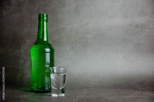 soju with glass on grey background, selective focus photo