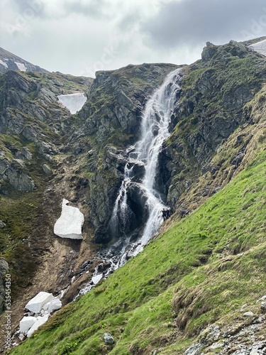 Vertical shot of a waterscape falling down the rocks photo