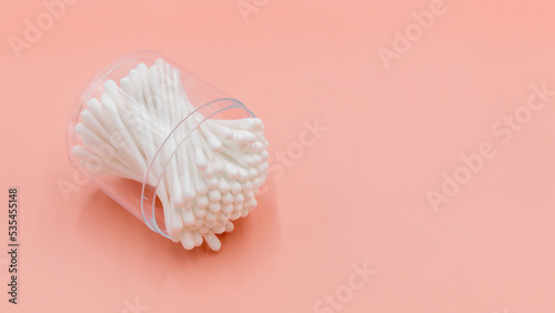 Cotton buds in box on a white background, Top view flat lay swabs cotton buds on orange background with copy space.