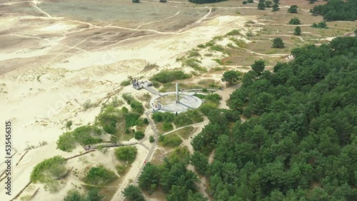 Drone footage of parnidis Dune sundial on sunny summer afternoon, drone flying round and opens Baltic sea view photo