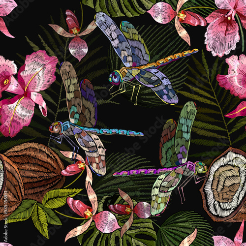 Tropical pattern. Pink orchids flowers, dragonflies, coconut and palm leaves seamless background. Embroidery. Jungle night. Fashionable template for design of clothes, textiles