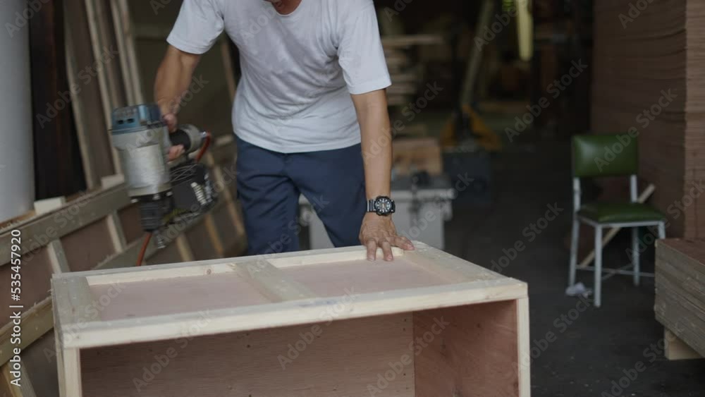 Man In White Shirt Doing Some Carpentry Work - medium shot Man In White Shirt Doing Some Carpentry Work - medium shot