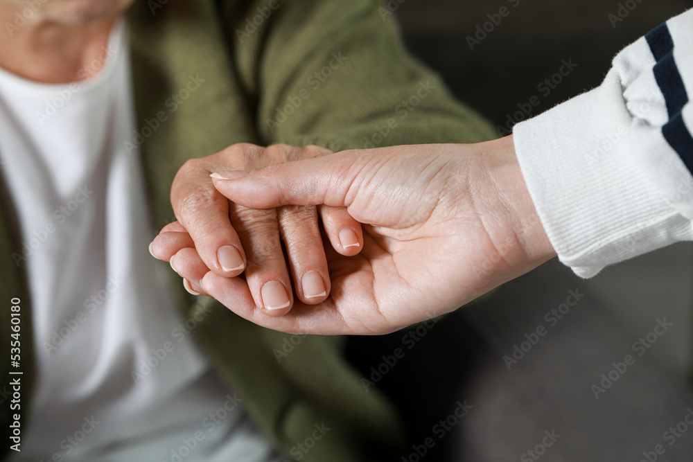 Caregiver helping elderly woman at home, closeup Caregiver helping elderly woman at home, closeup