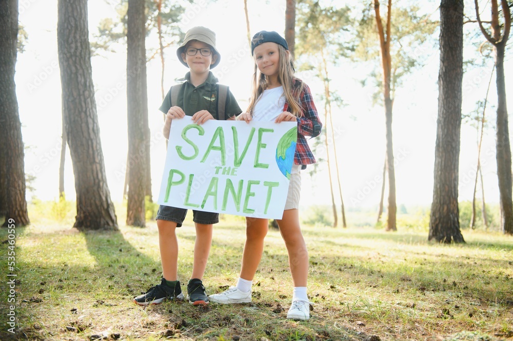 Children are holding a poster: Save the planet.